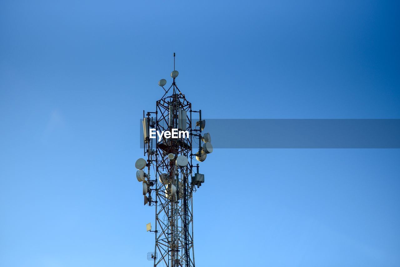 LOW ANGLE VIEW OF COMMUNICATIONS TOWER AGAINST SKY