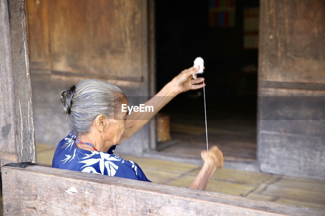 Woman holding thread