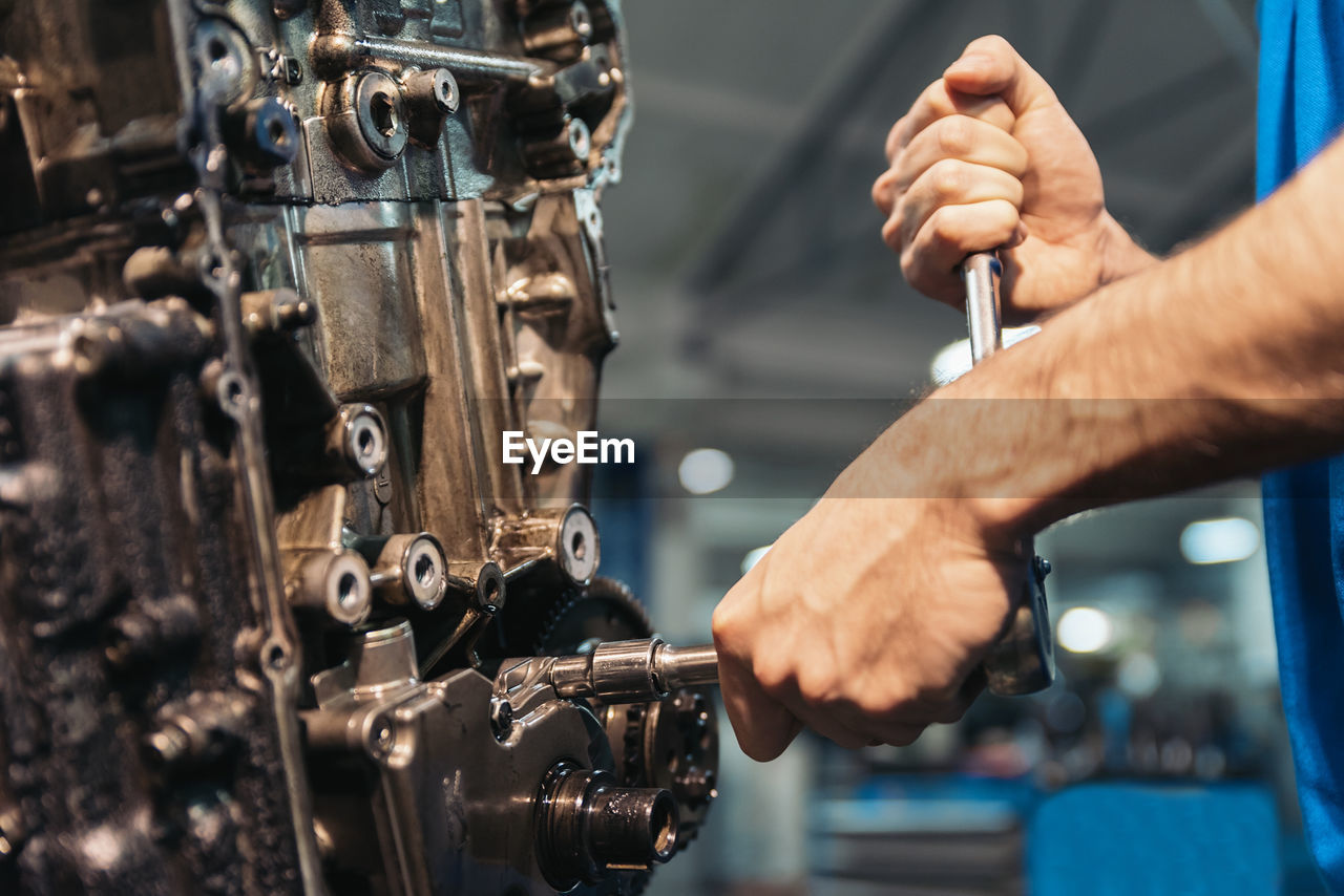 Close-up of man working in garage