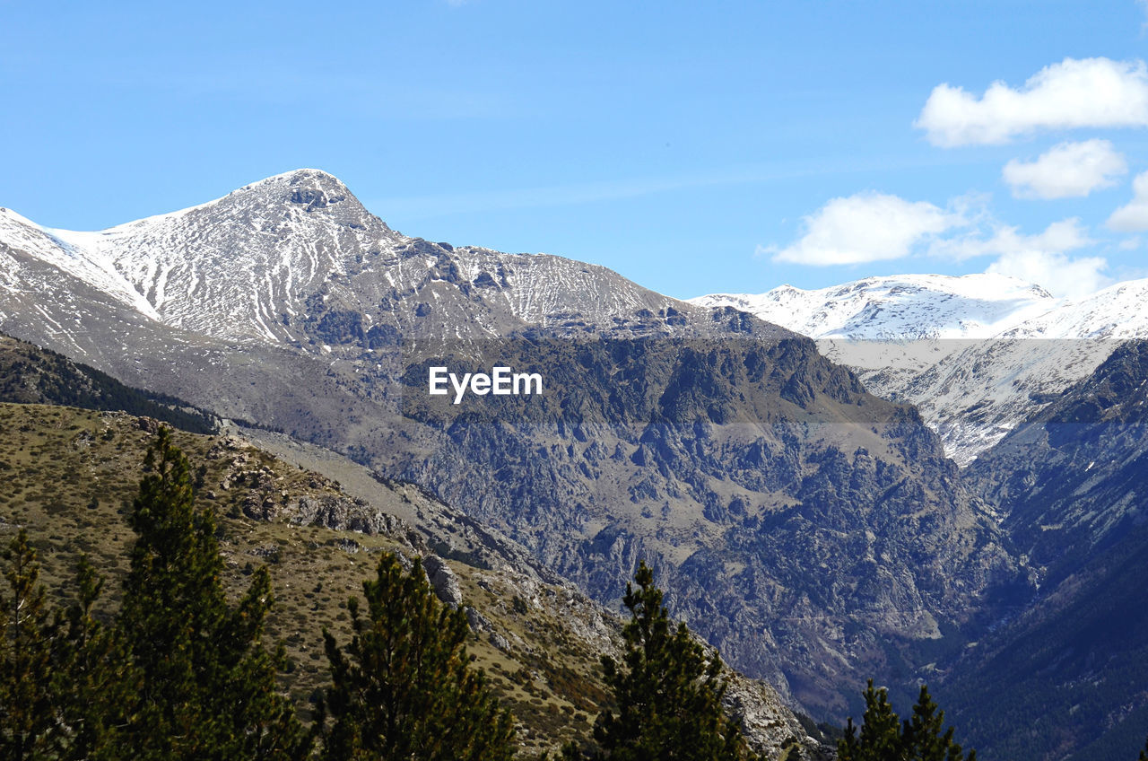 scenic view of snowcapped mountains against blue sky