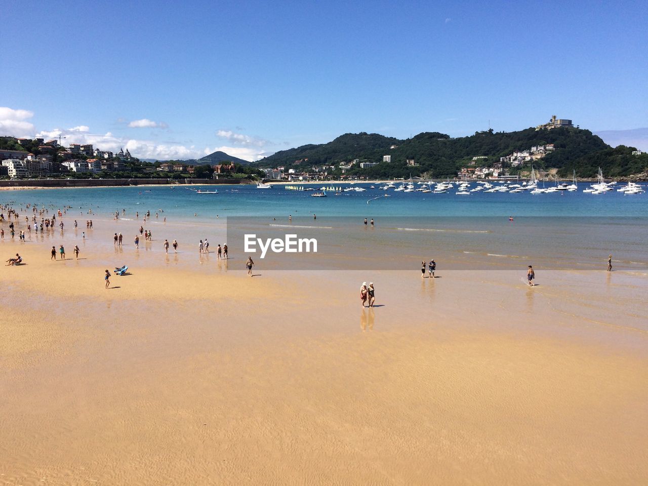 People at beach against sky