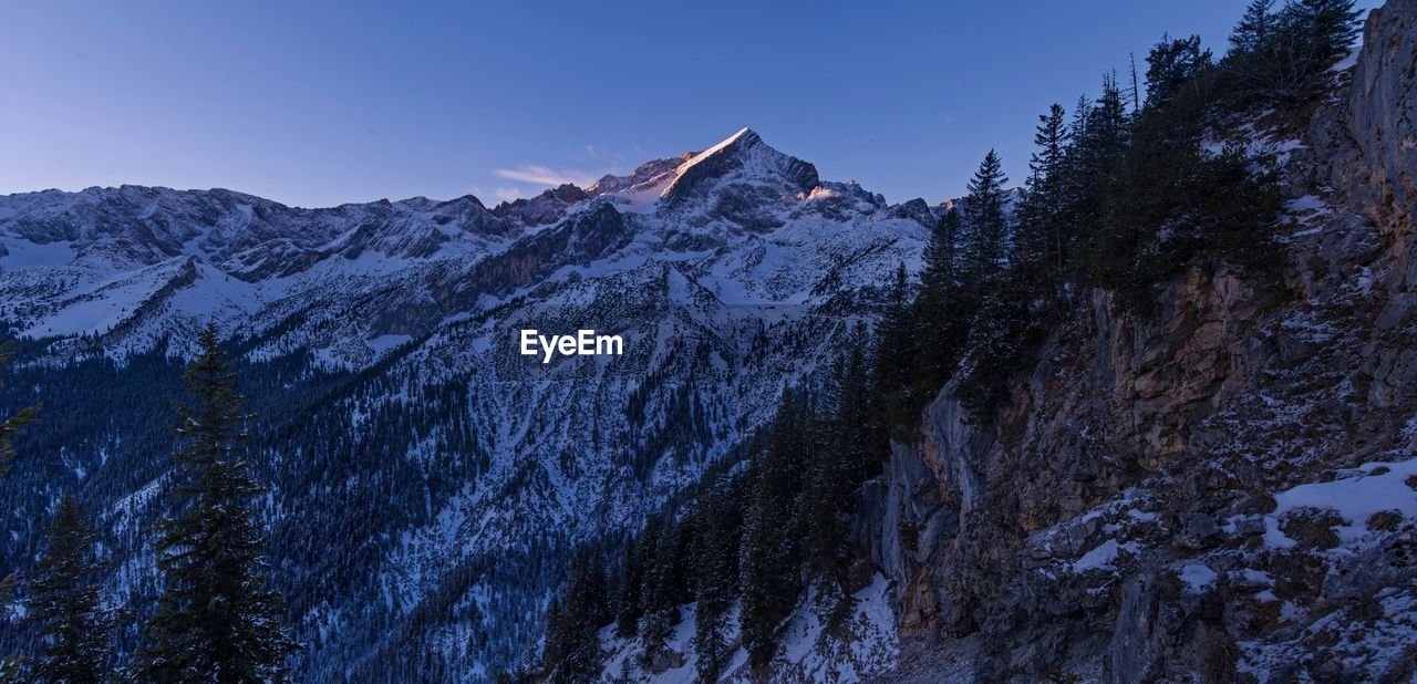 Scenic view of snowcapped mountains against sky