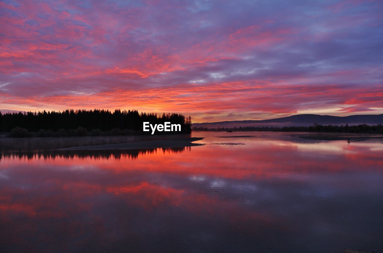 scenic view of river against sky during sunset