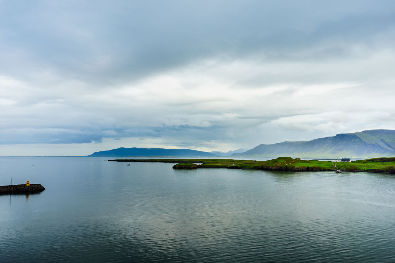 SCENIC VIEW OF SEA BY MOUNTAIN AGAINST SKY