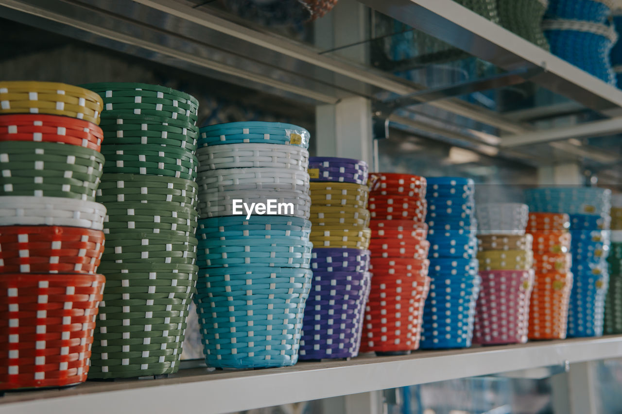 Multi colored baskets for sale at market stall