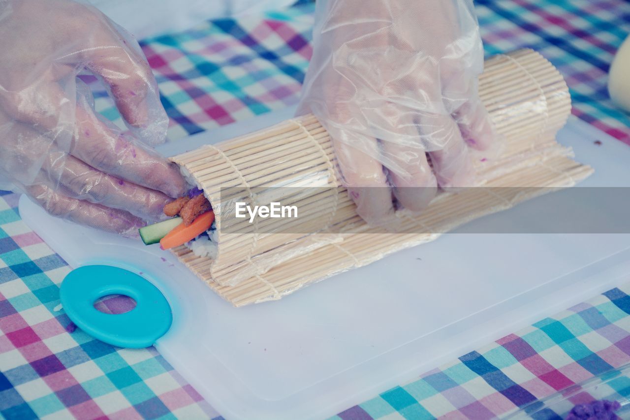 HIGH ANGLE VIEW OF PERSON PREPARING FOOD