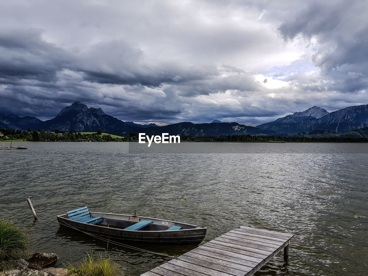 Scenic view of lake against cloudy sky