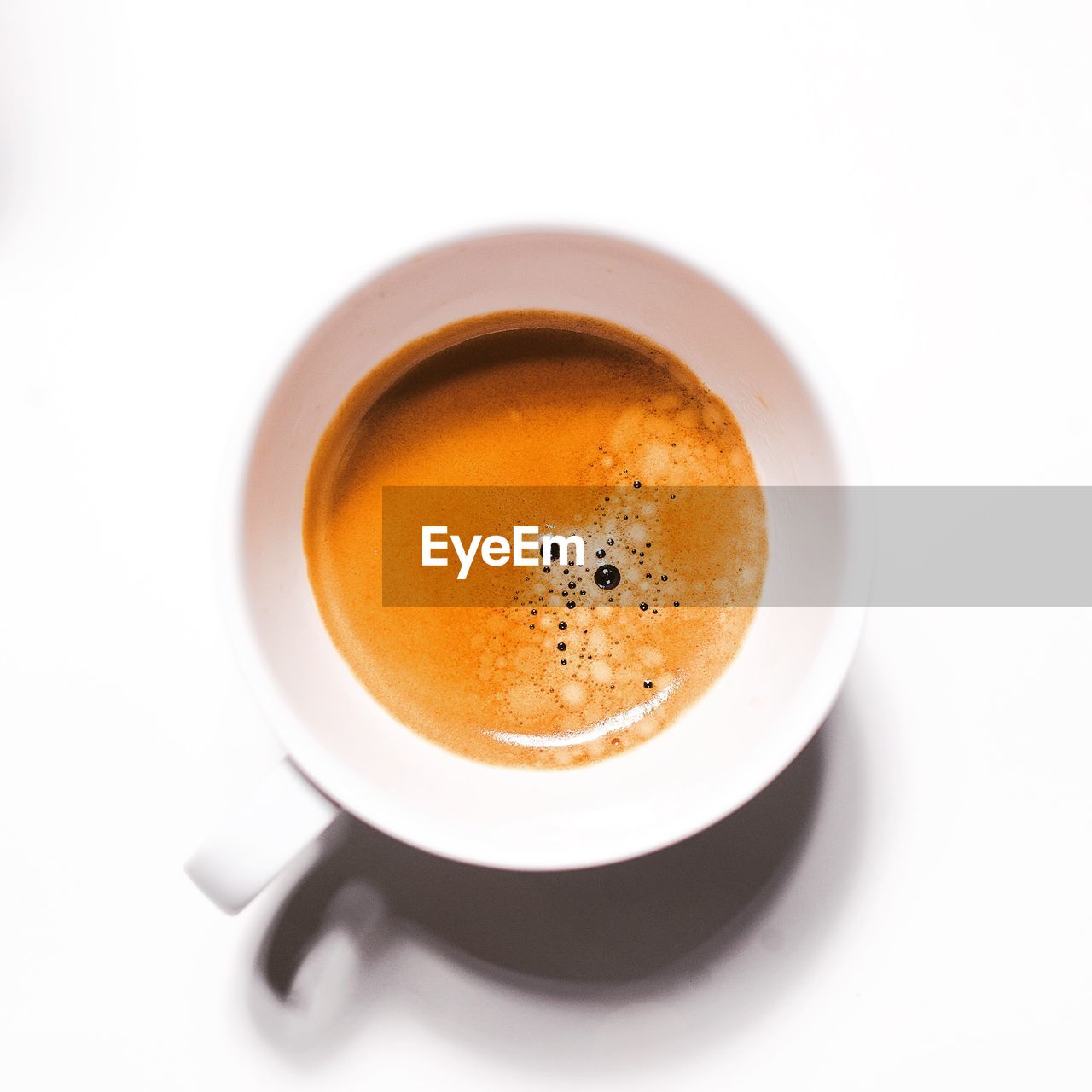 High angle view of coffee cup over white background