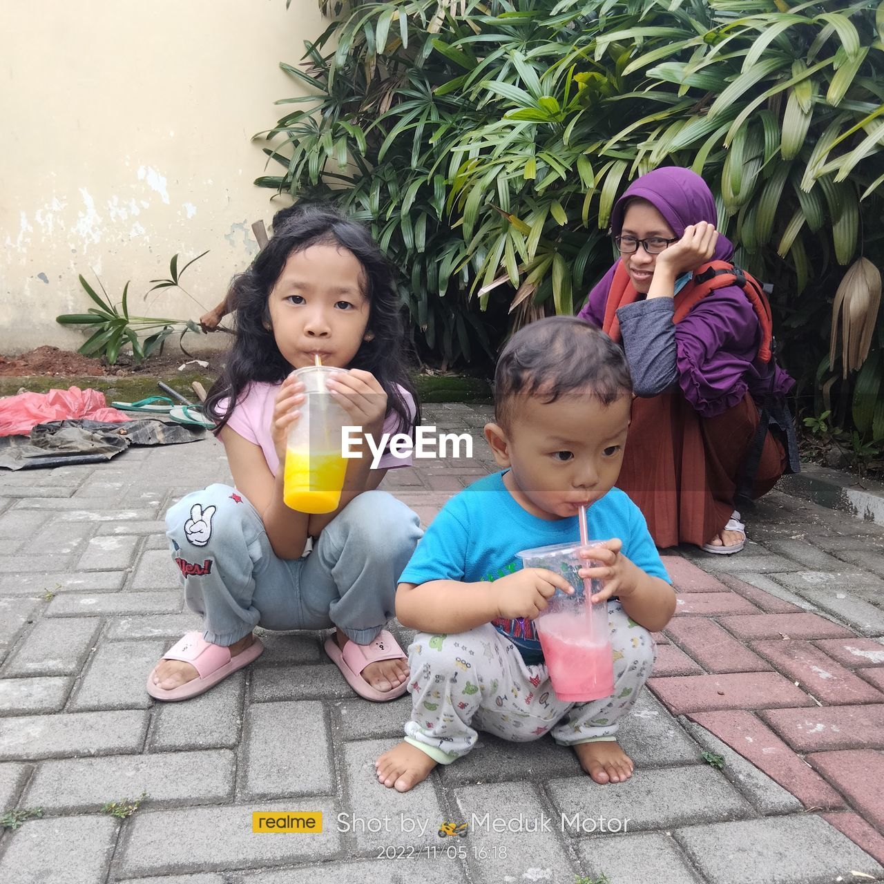 high angle view of cute girl sitting on street