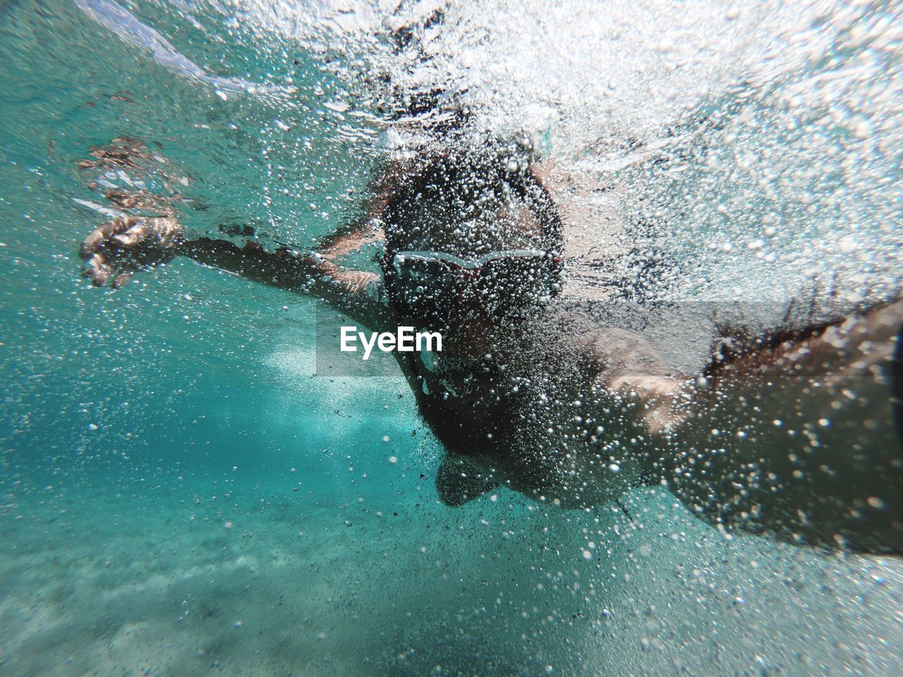 Close-up of man swimming undersea