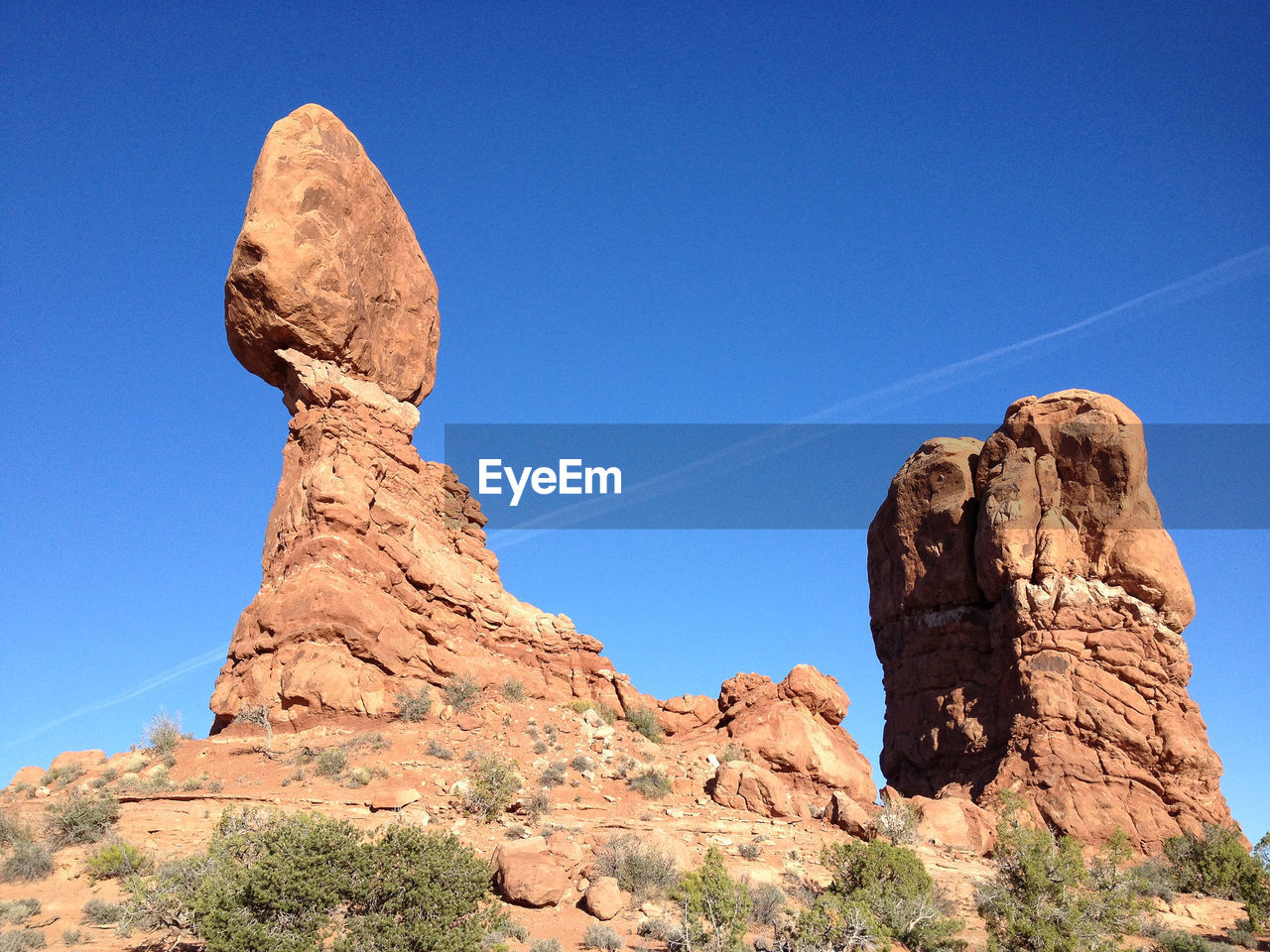 Low angle view of rock formations against clear blue sky