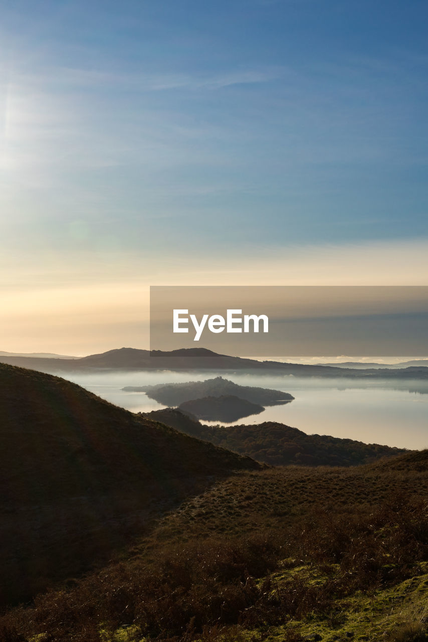 SCENIC VIEW OF LAND AND MOUNTAINS AGAINST SKY