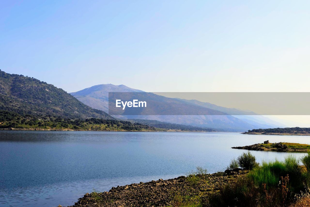 Scenic view of lake and mountains against sky