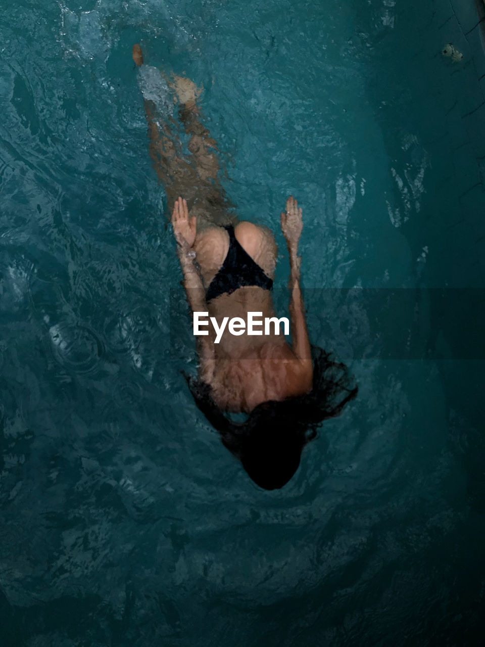 High angle view of woman swimming in pool