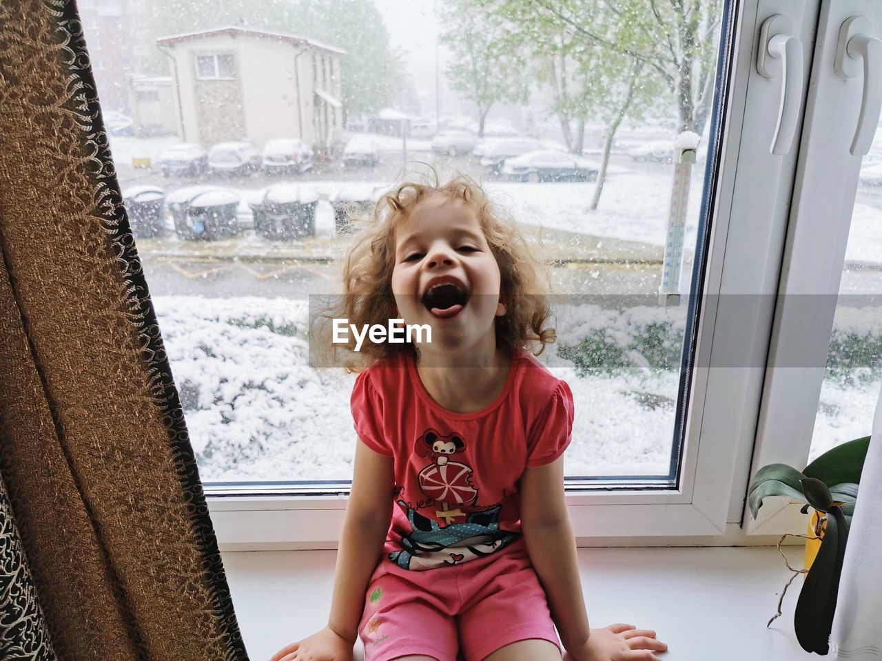 GIRL SITTING ON WINDOW