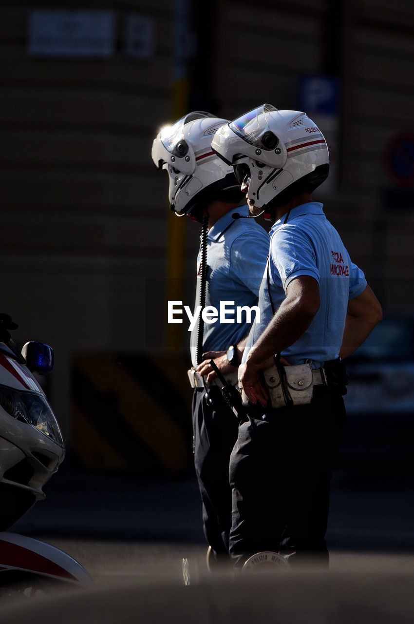 Police officers wearing helmet standing in city