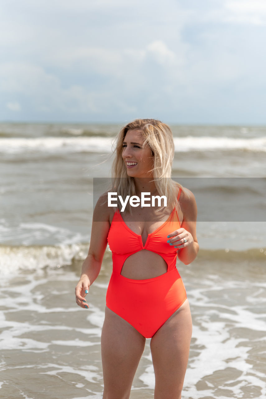 Young woman standing at beach