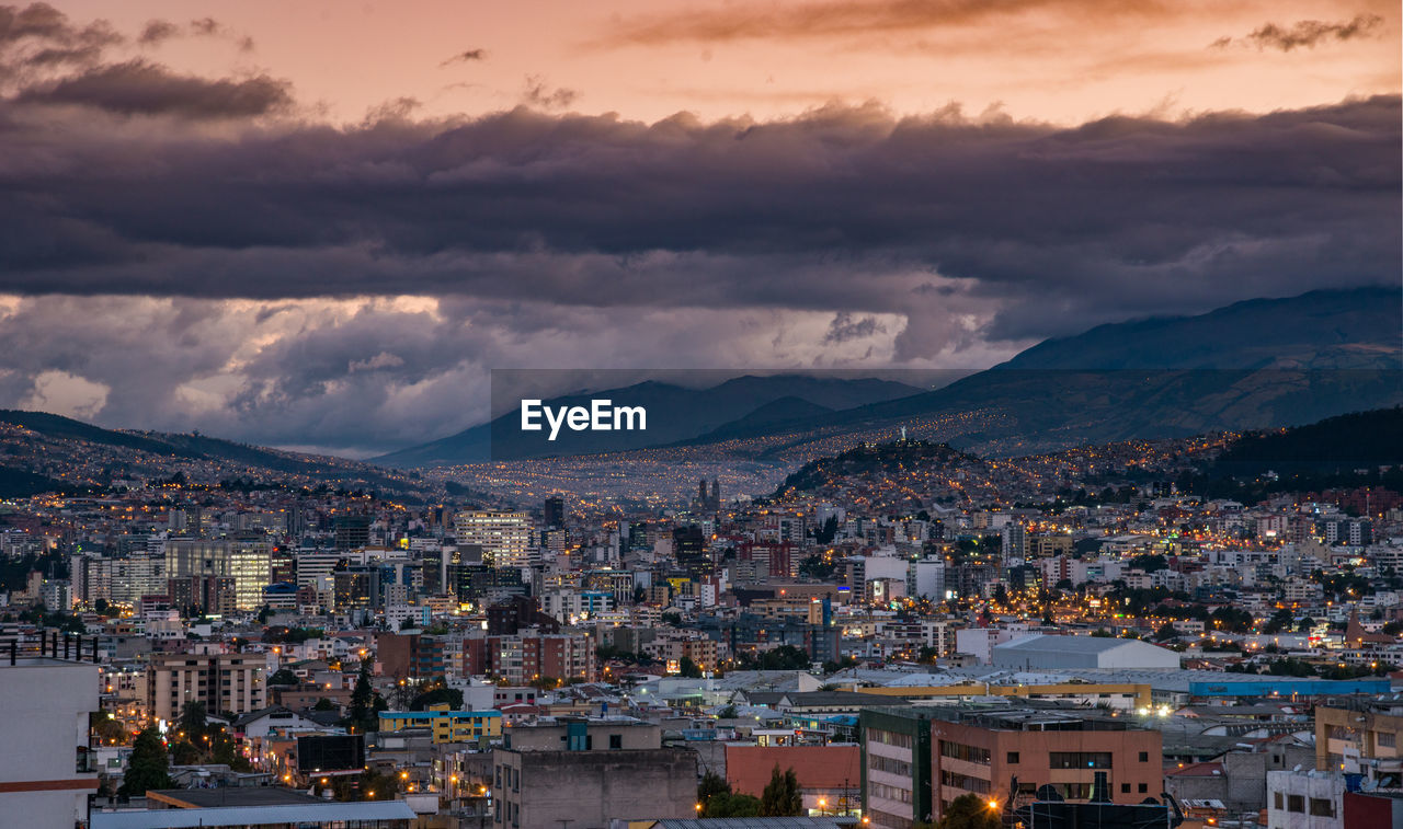 Aerial view of townscape against sky at sunset