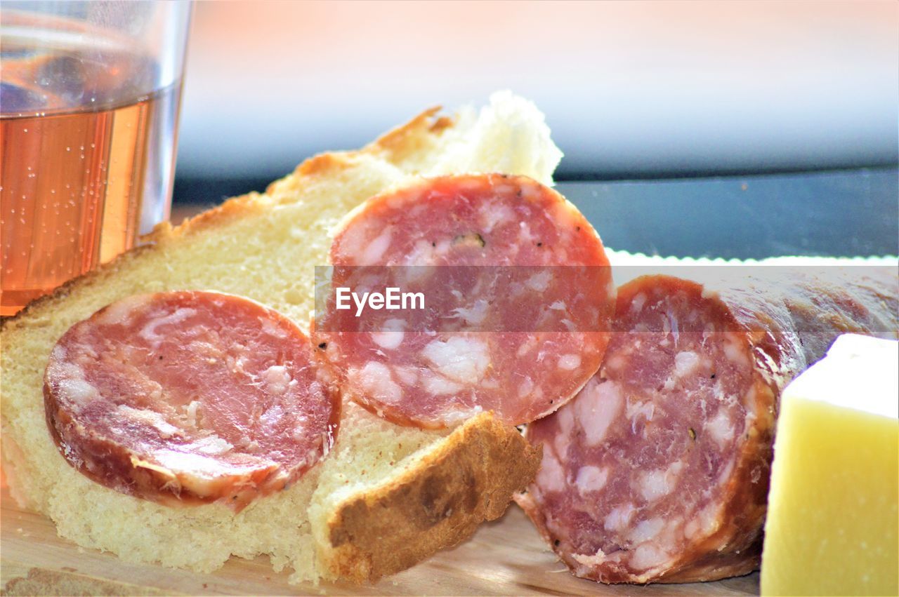 CLOSE-UP OF FRESH BREAD IN GLASS WITH TABLE