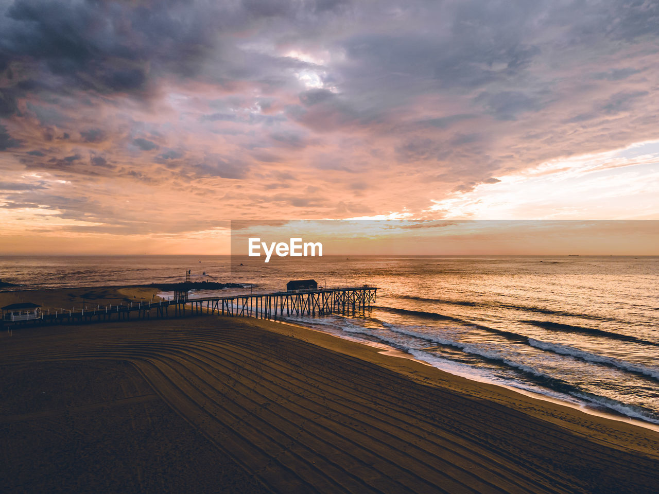 Scenic view of beach against sky during sunset