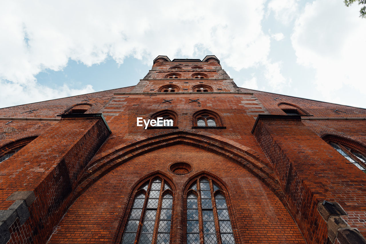 Low angle view of st. peter church against sky in lubeck, germany.