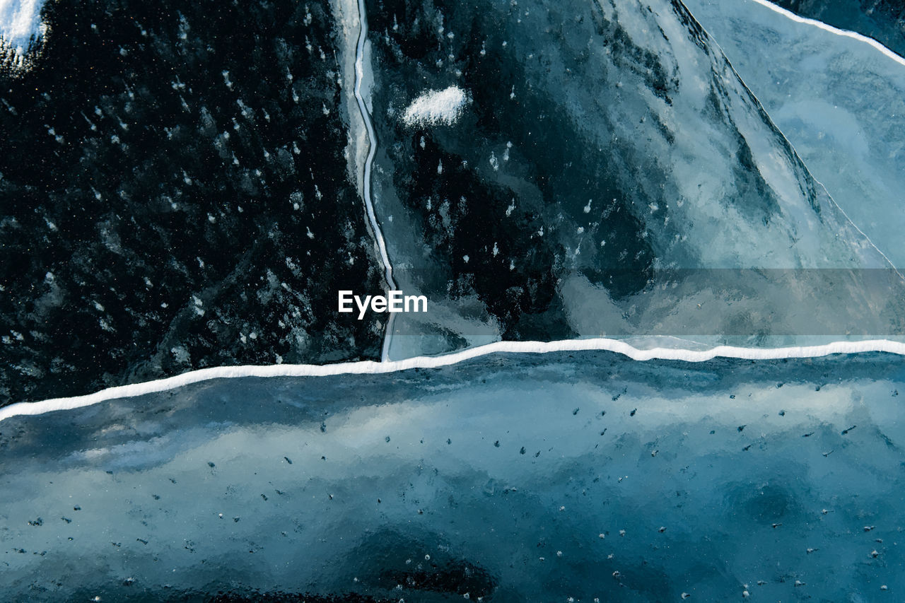 Close-up of snow on sea against sky