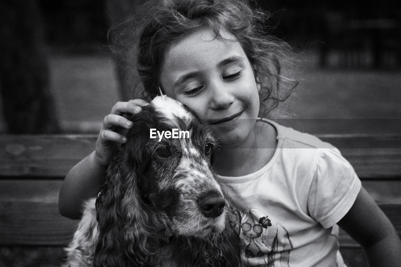 Girl with dog on bench