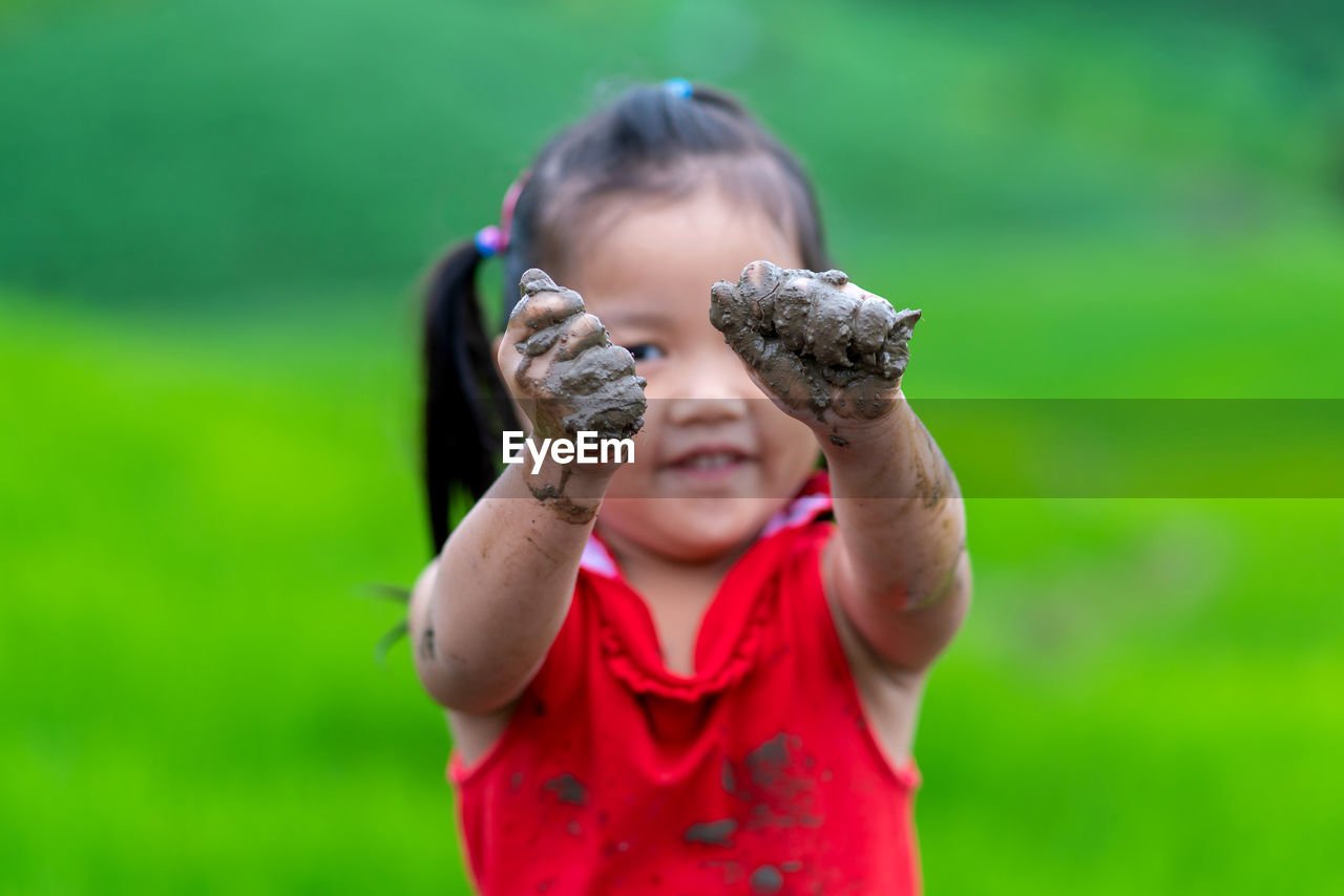 Happy girl very fun play mud