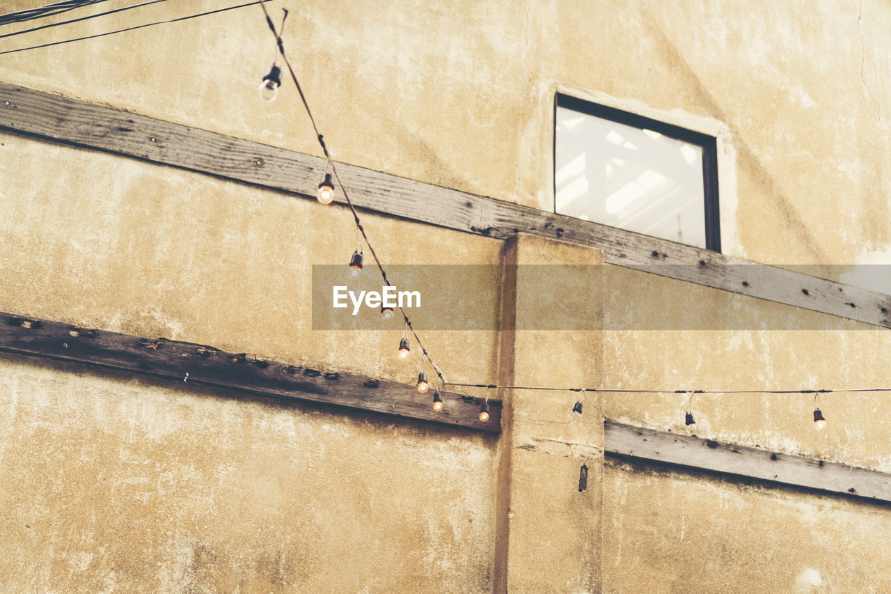 LOW ANGLE VIEW OF OLD BUILDING AGAINST WALL