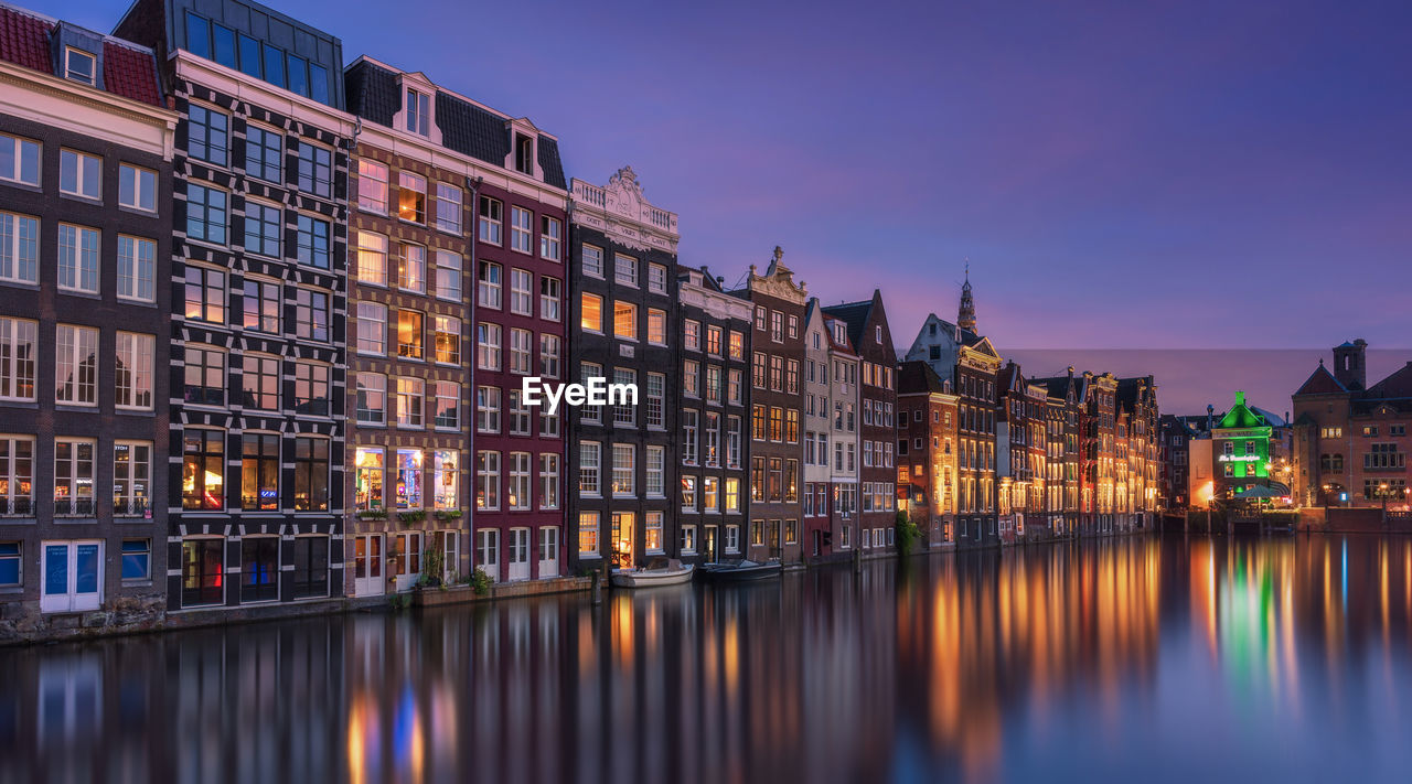 Reflection of buildings in city at night amsterdam 