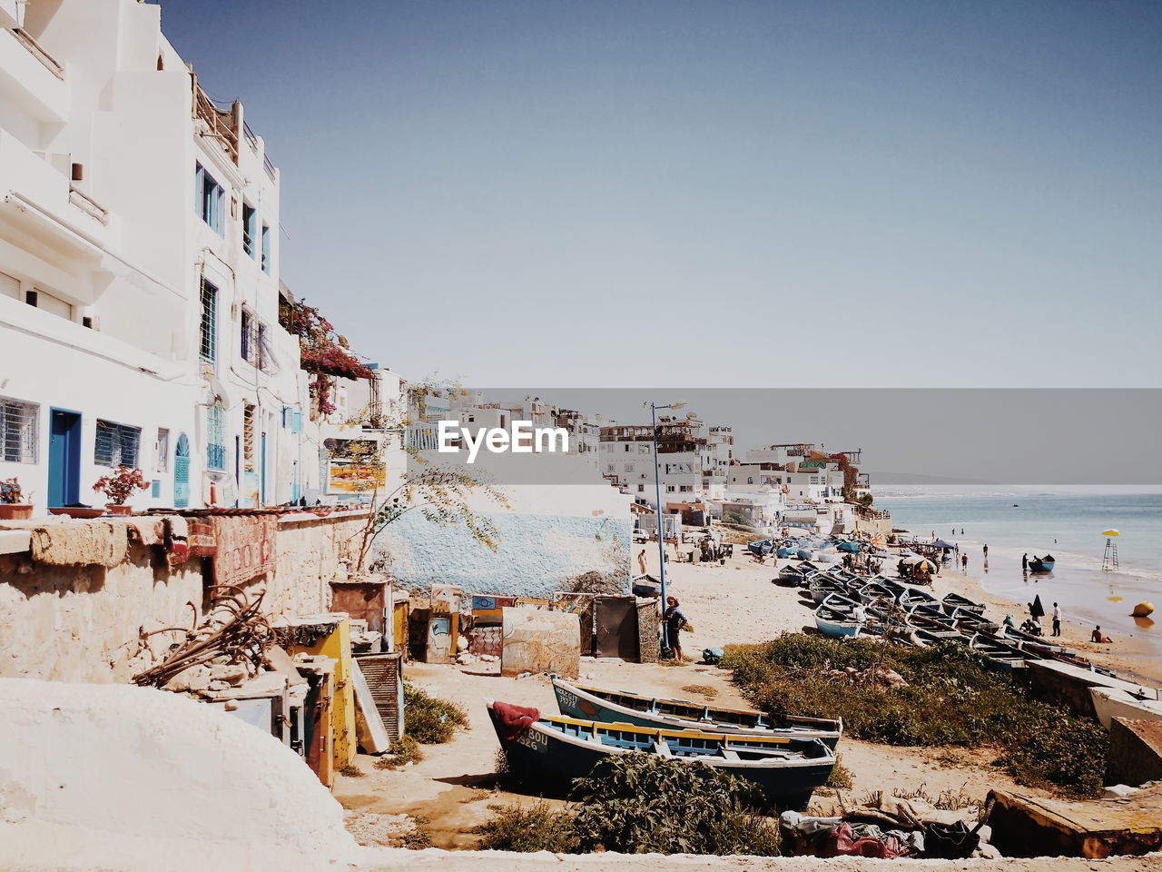 BUILT STRUCTURE ON BEACH AGAINST BUILDINGS