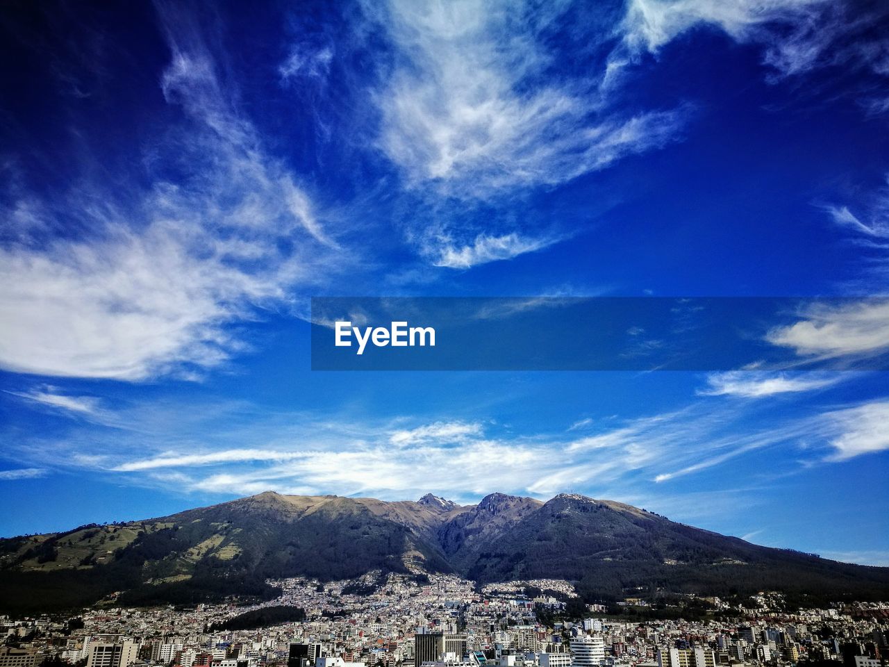 Scenic view of mountains against blue sky