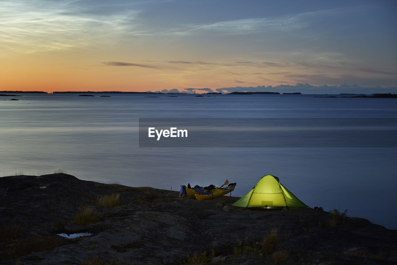 View of illuminated tent at sea