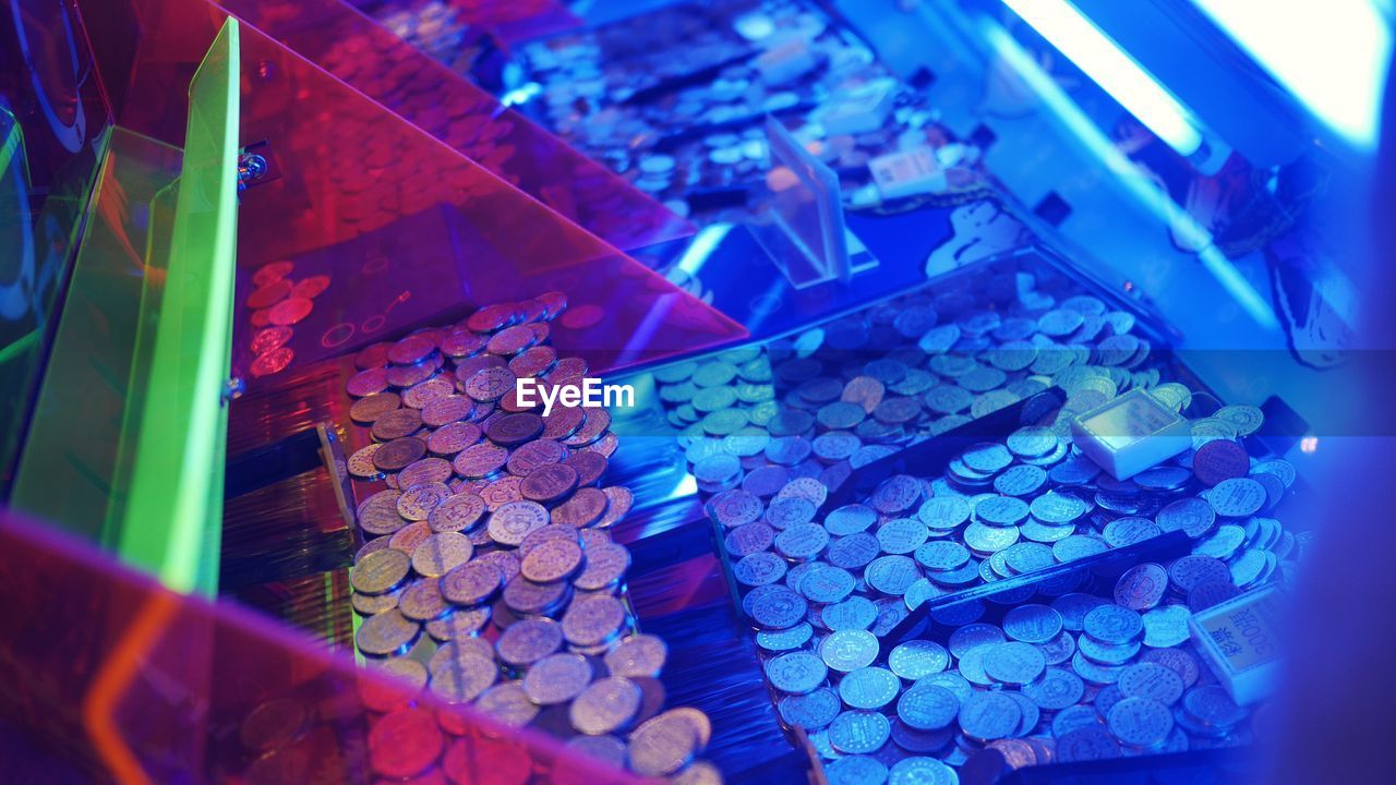 High angle view of coins in illuminated container