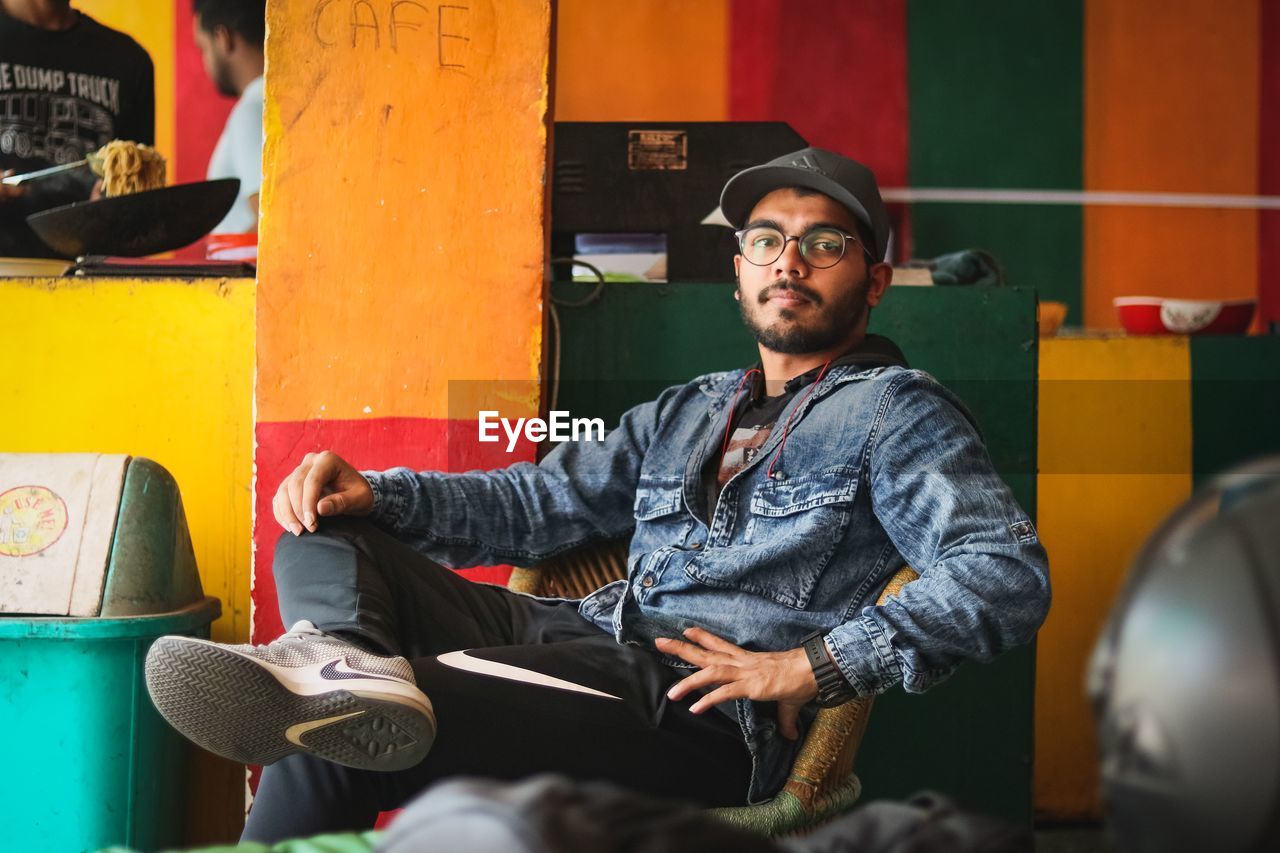 FULL LENGTH OF MAN SITTING ON CHAIR AT BUS