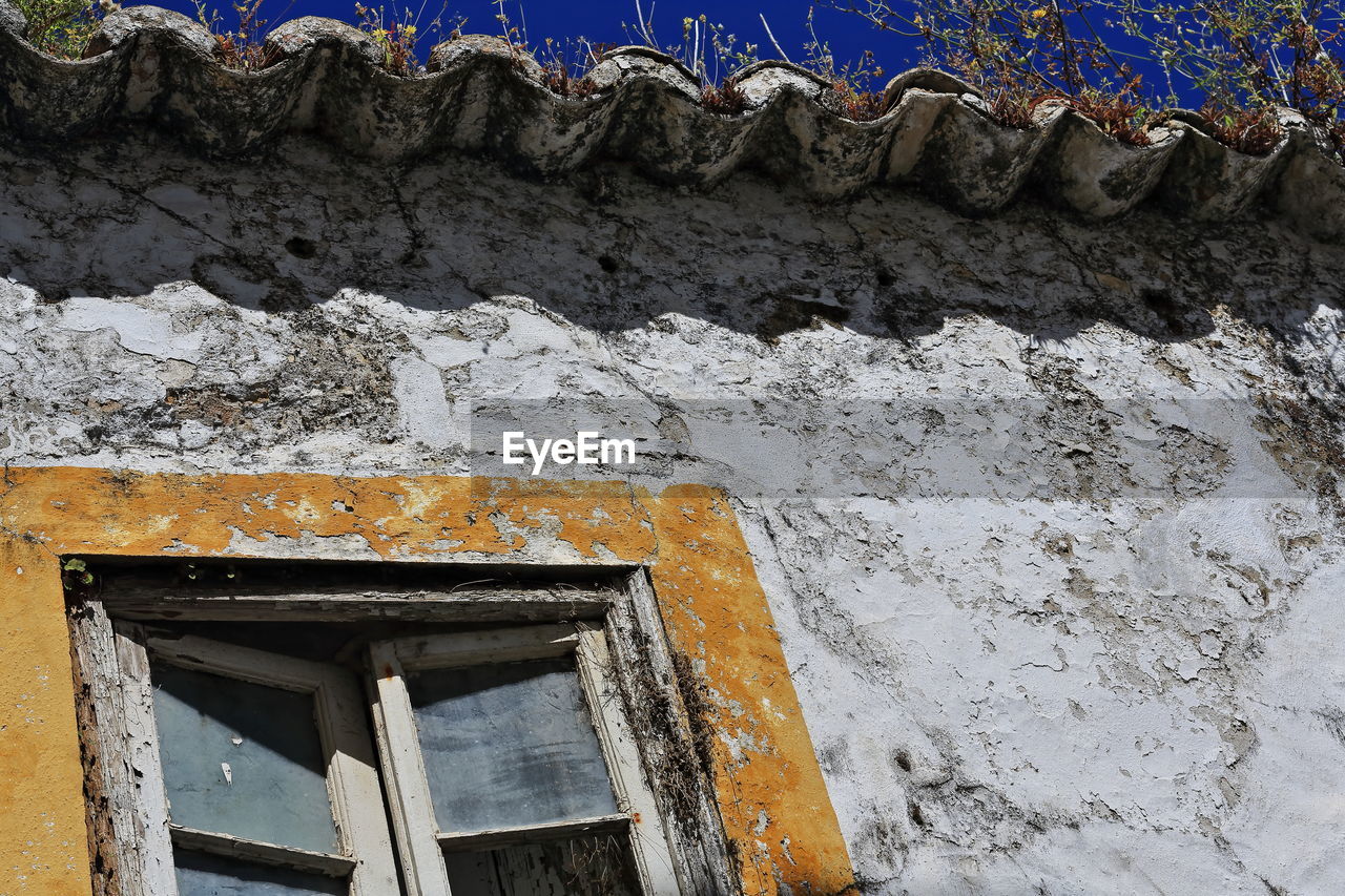 wall, architecture, built structure, building exterior, no people, blue, building, day, house, window, wall - building feature, low angle view, outdoors, ancient history, nature, old, snow