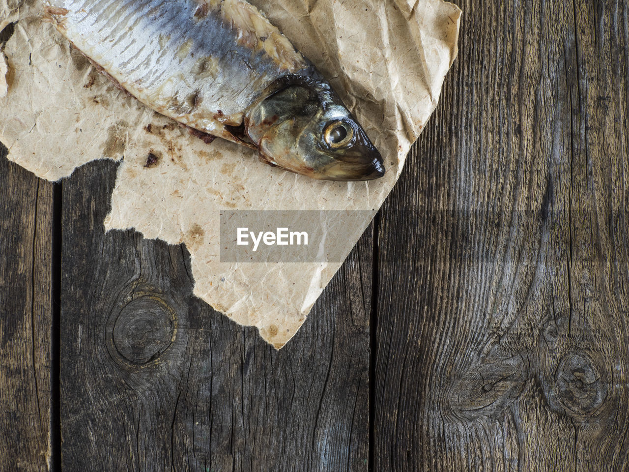 Close-up of herring on paper at table