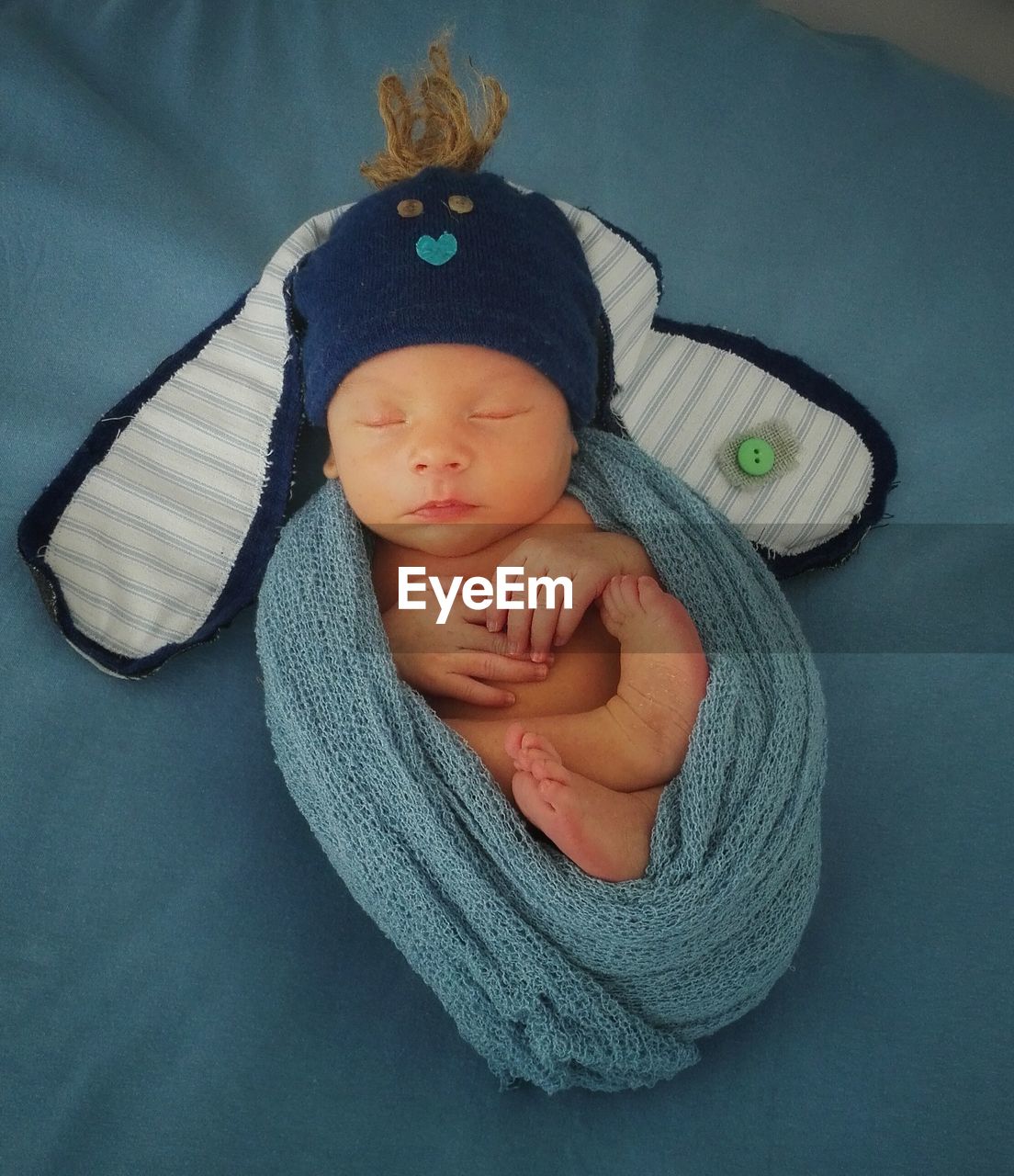 High angle view of newborn sleeping on bed