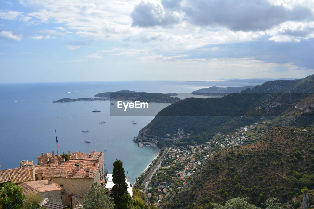 High angle view of buildings by sea against sky