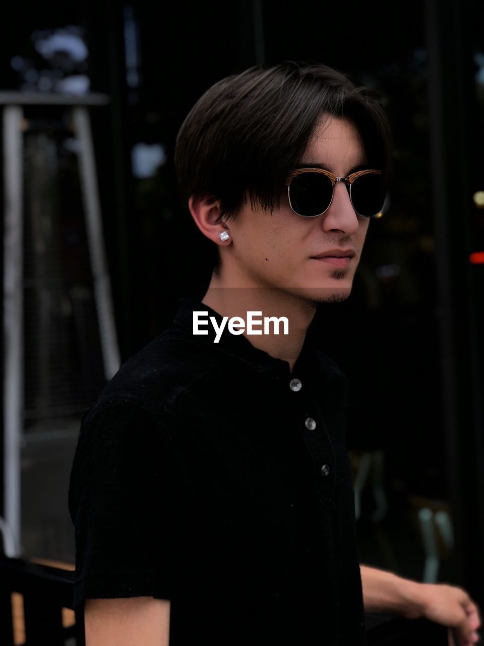 Close-up of young man wearing sunglasses while standing outdoors