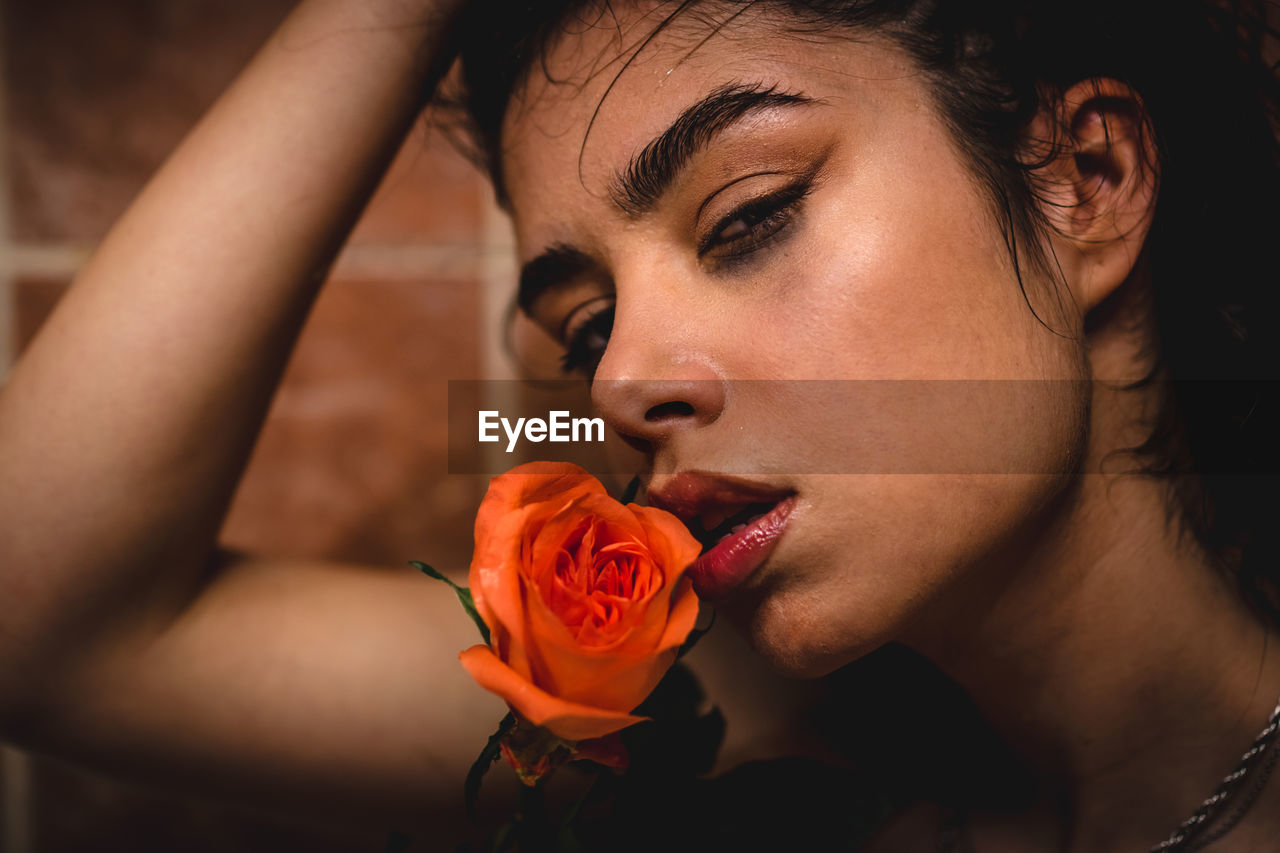 Close up picture of woman face with beauty skin tone and wet lips. female and roses