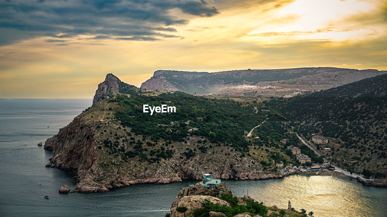 SCENIC VIEW OF BAY AGAINST SKY DURING SUNSET