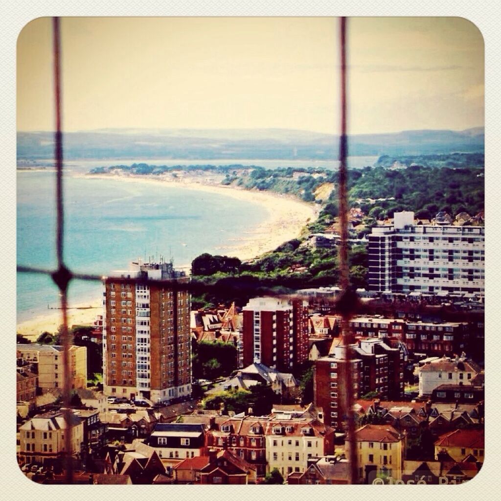 VIEW OF CITYSCAPE WITH SEA IN BACKGROUND