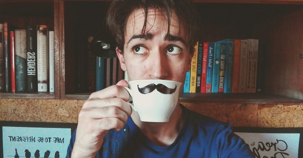 Optical illusion of man with mustache drinking coffee