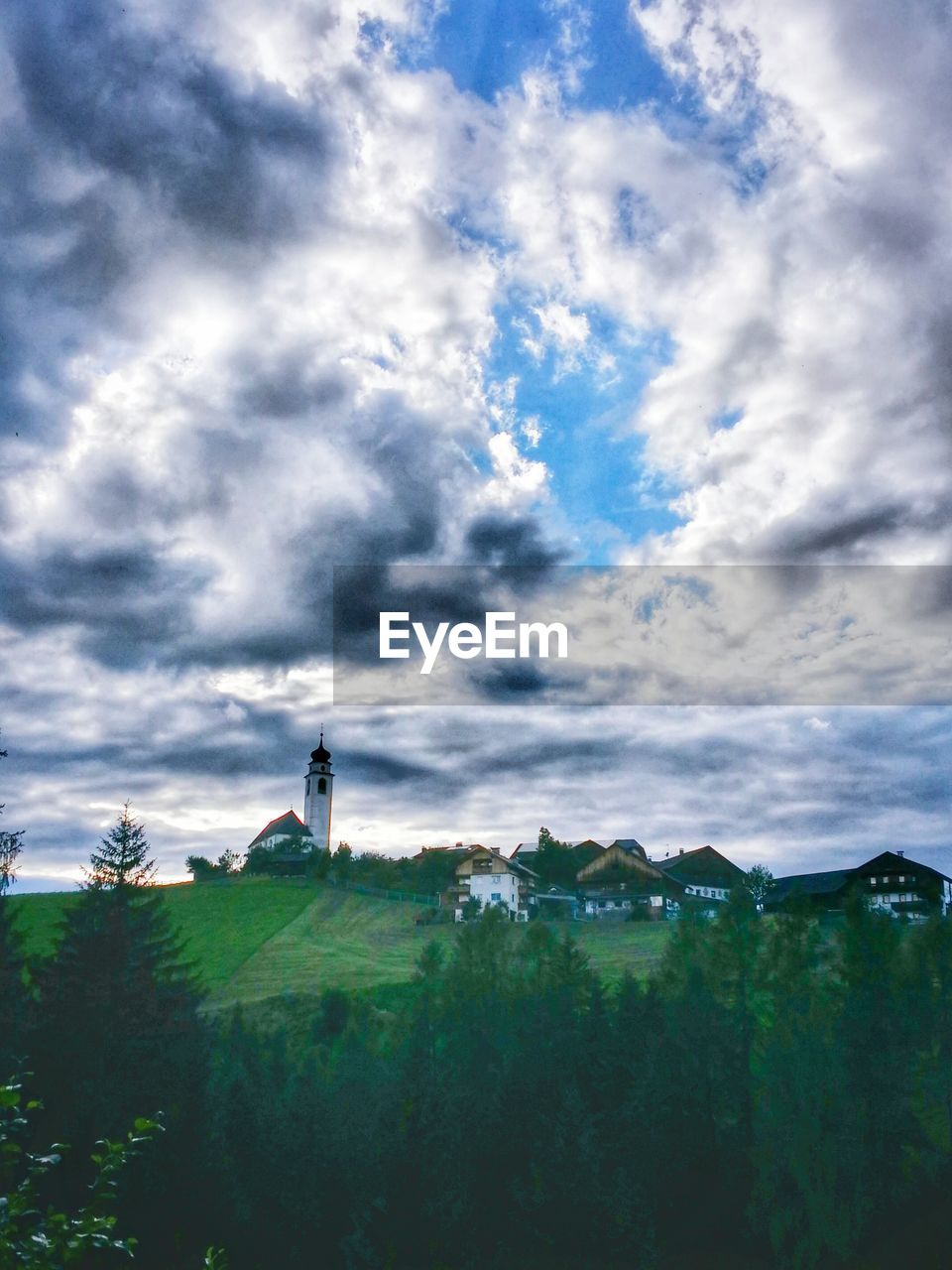 VIEW OF FIELD AGAINST CLOUDY SKY