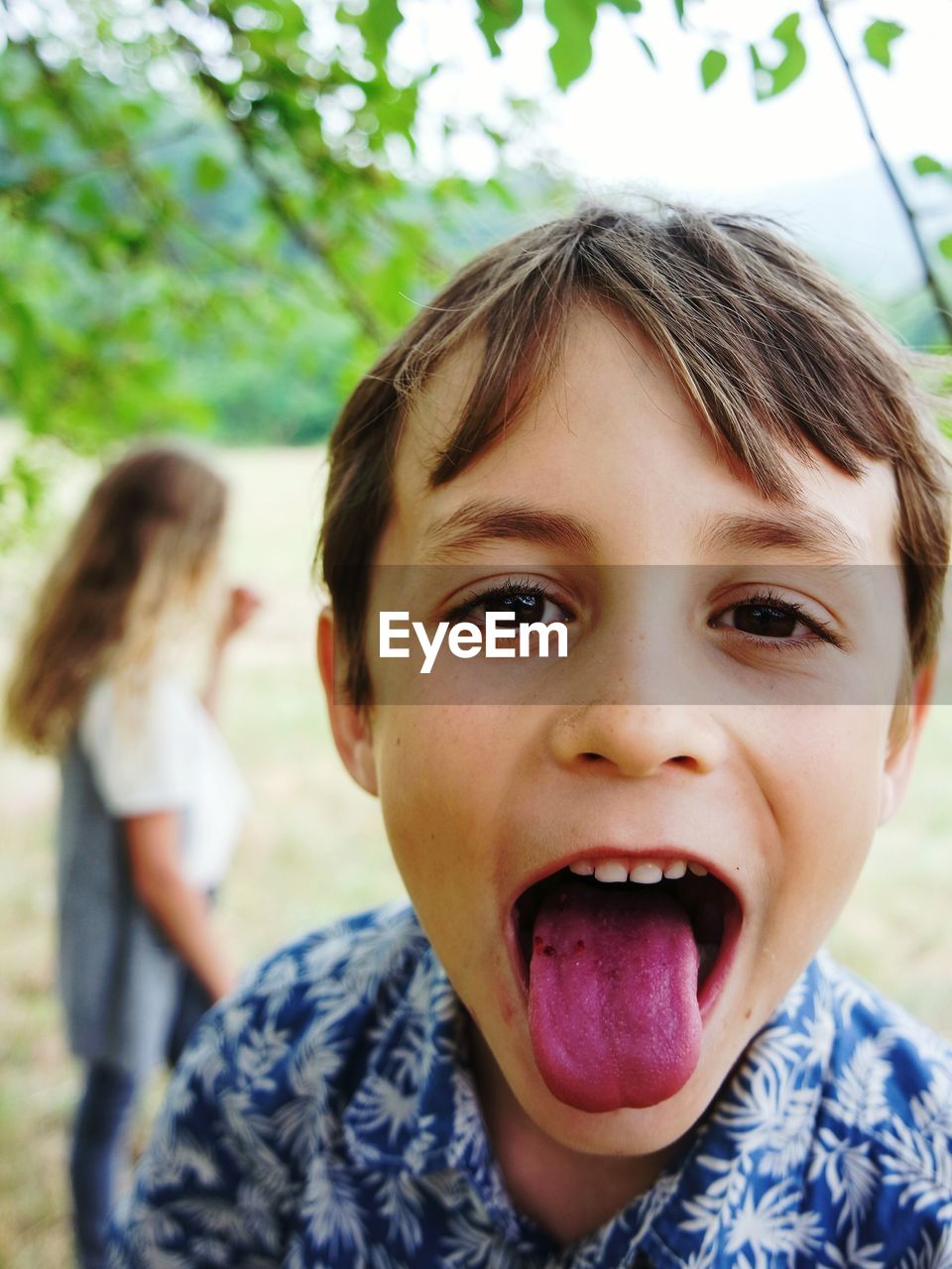 Close-up portrait of boy sticking out tongue