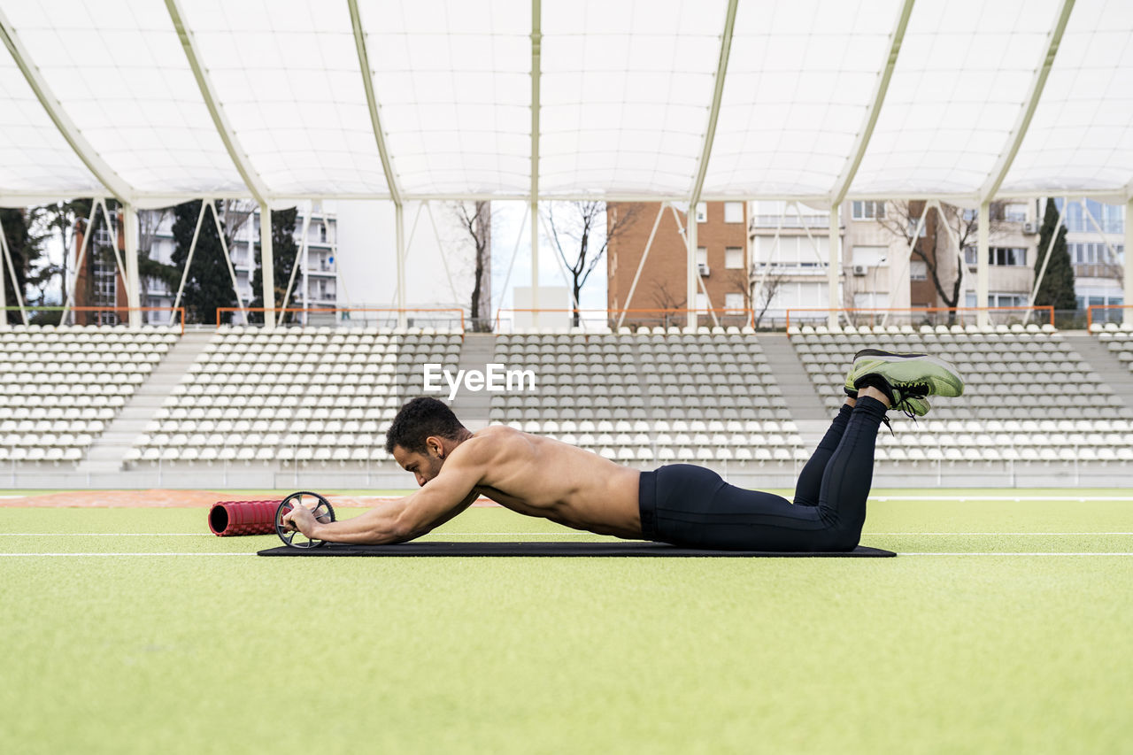 Male athlete exercising on sports field