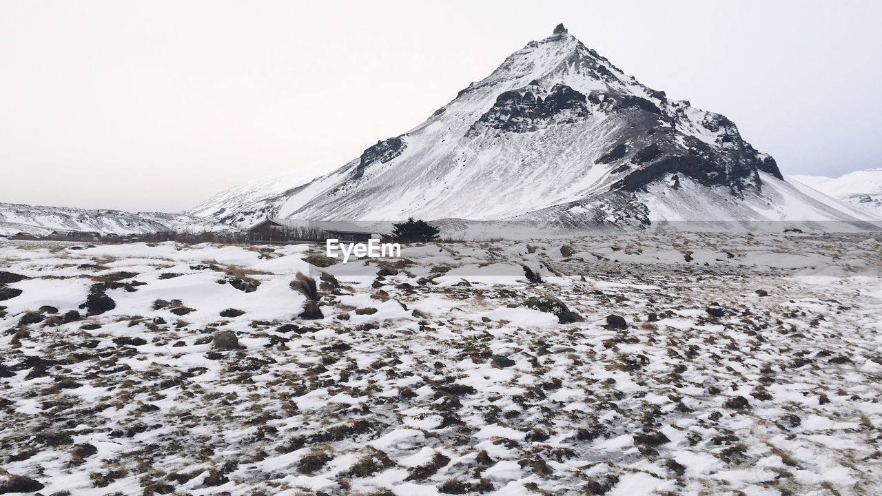 Scenic view of snowcapped mountains against clear sky