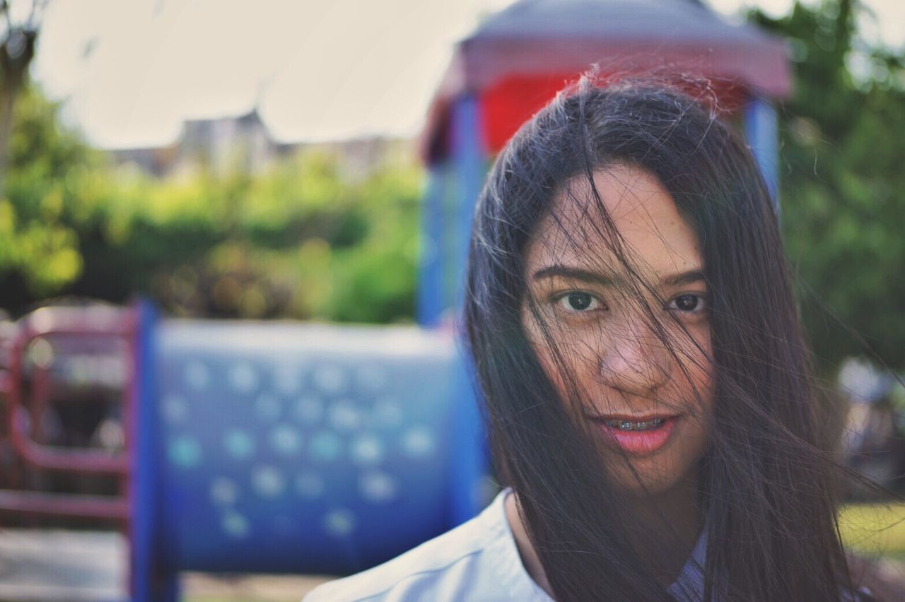 Portrait of smiling young woman in city