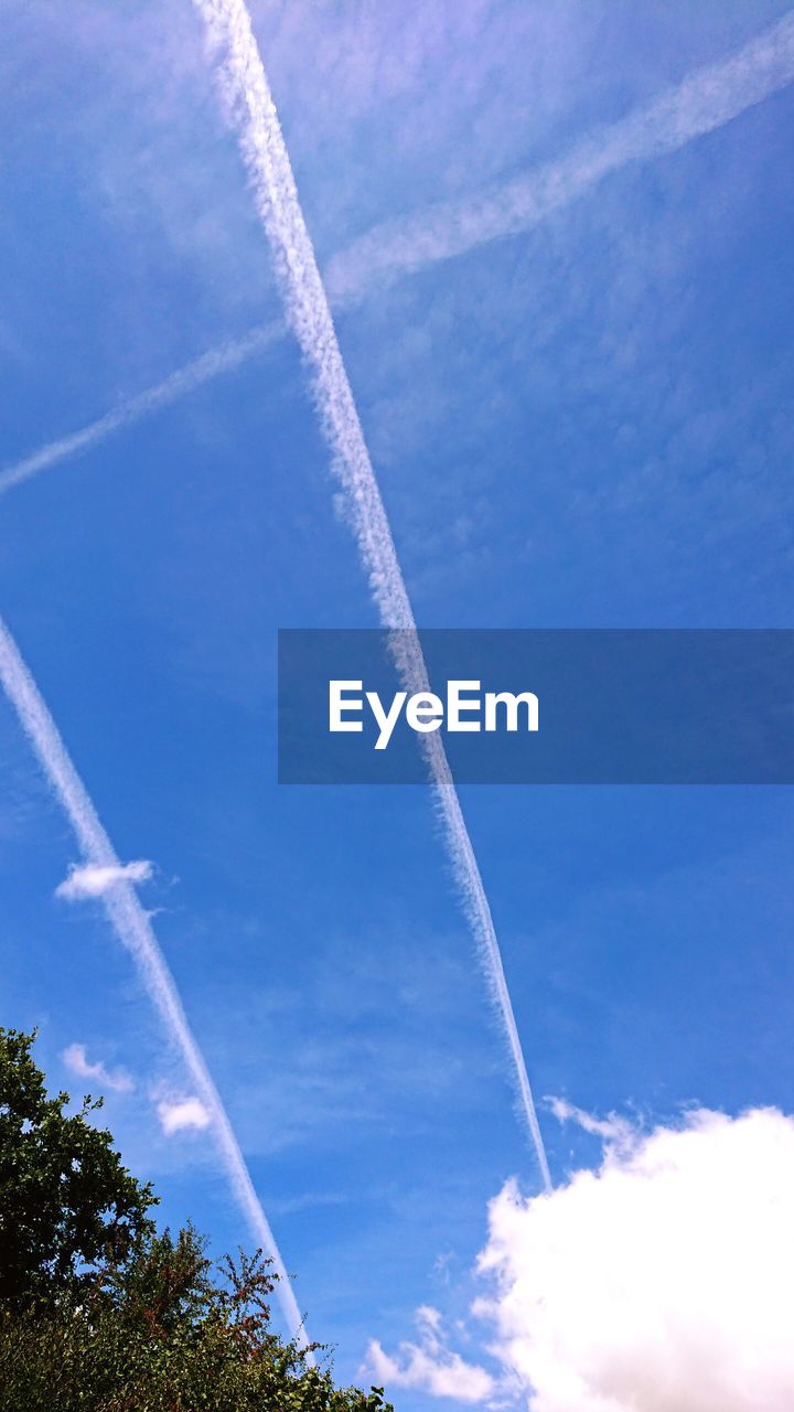 LOW ANGLE VIEW OF VAPOR TRAILS IN SKY